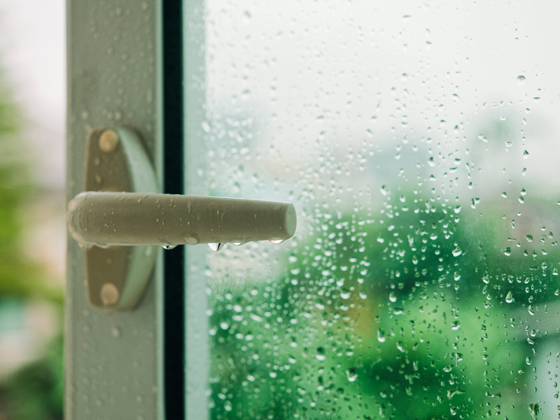 Raindrop on Door with Handle and Blur tree background